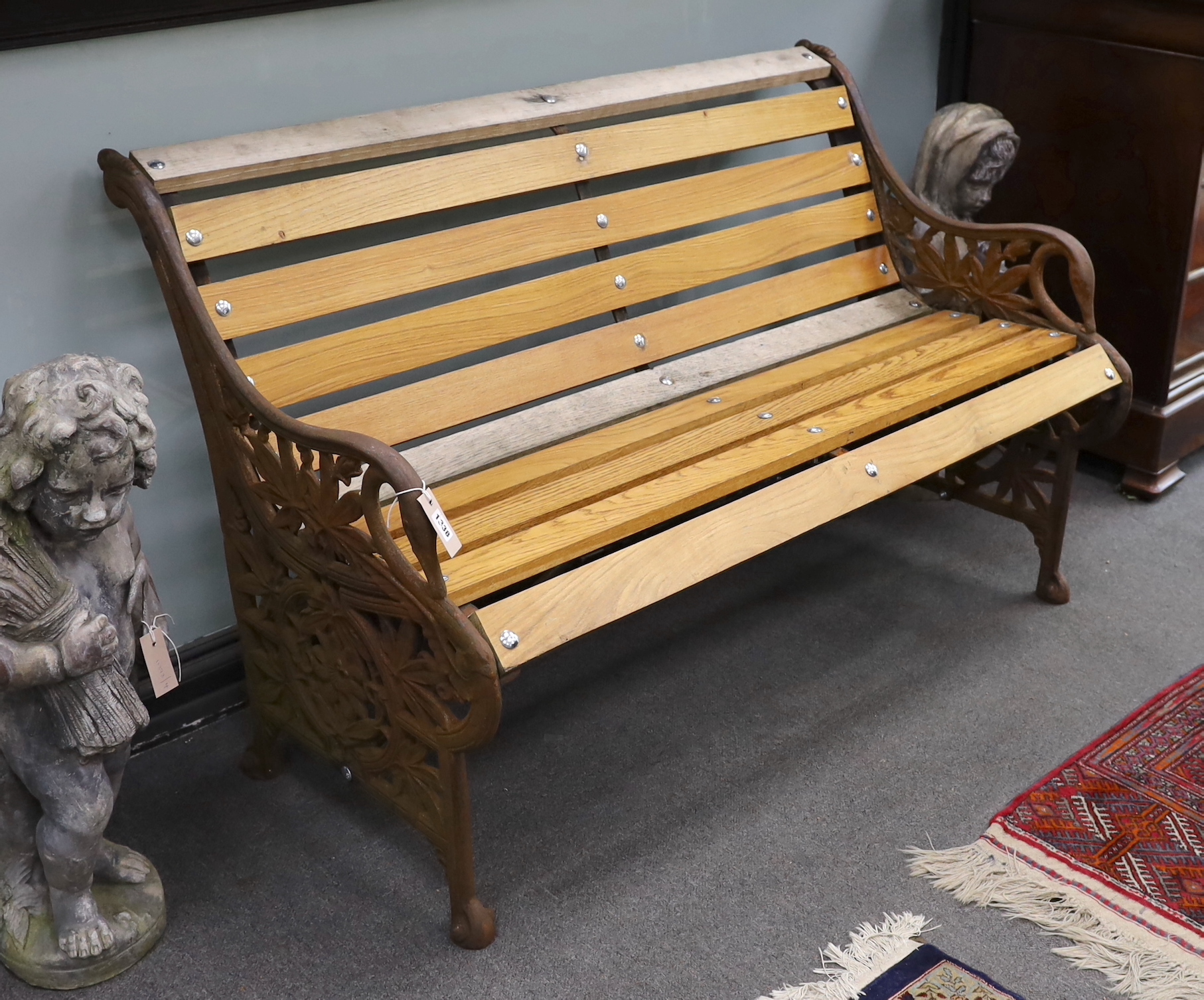 A Victorian Coalbrookdale passion flower pattern cast iron garden bench restored with later ash slats, length 129cm, depth 64cm, height 82cm